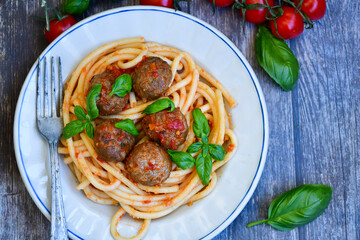 Spaghetti pasta Italian home made meal. Mediterranean food concept .Spaghetti pasta meatballs with tomato sauce, basil, herbs ,parmesan cheese 