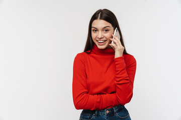 Photo of happy young woman smiling while talking on mobile phone