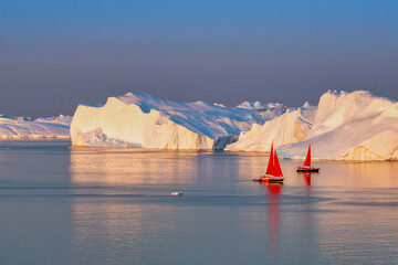 Greenland Ilulissat glaciers at ocean with res sailing boat © Jaro