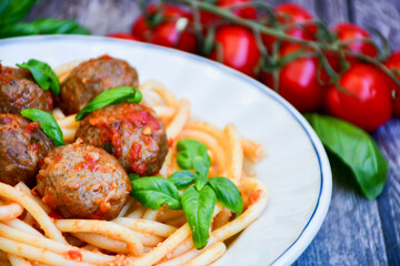 Spaghetti pasta Italian home made meal. Mediterranean food concept .Spaghetti pasta meatballs with tomato sauce, basil, herbs ,parmesan cheese 