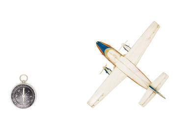 Still life with a scale model of a  plane and compass. Travel concept. Top view travel or vacation concept. Traveler accessories on a white background with blank space for text.  © Roman