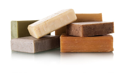 Pile of pieces of different home made soap closeup isolated on white