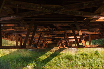 Fototapeta na wymiar Metal constructions of the railway bridge over the river