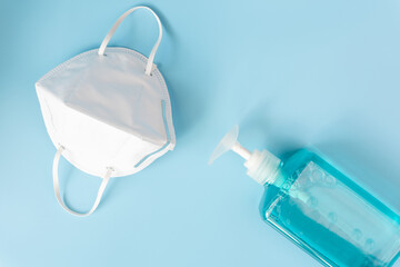 Surgical mask   and  hand sanitizer spray bottle for washing hand   on blue and white...