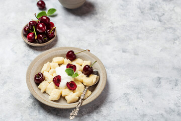 cottage cheese dumplings with sour cream and cherries