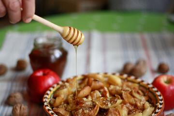Baked apples with honey and walnuts on the table