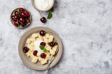 cottage cheese dumplings with sour cream and cherries