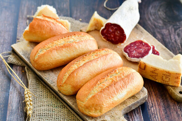 Home  baked bread  , hand made artisan dried    italian   pork salami,  and parmesan cheese .