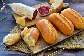 Home  baked bread  , hand made artisan dried    italian   pork salami,  and parmesan cheese .