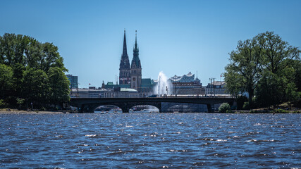 Fototapeta premium Kennedybrücke mit Alsterfontäne und Rathausturm, St.Nikolai und Elbphilharmonie