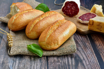 Fresh baked bread and italian dried salami  on wooden table