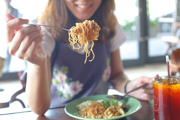 young woman eating noodle