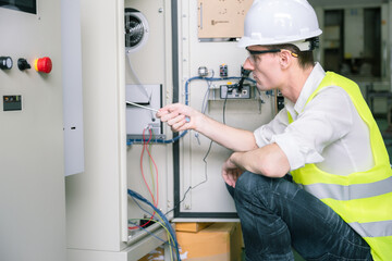 Metal worker teaching trainee on machine use