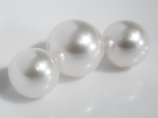 three white pearls on a white background