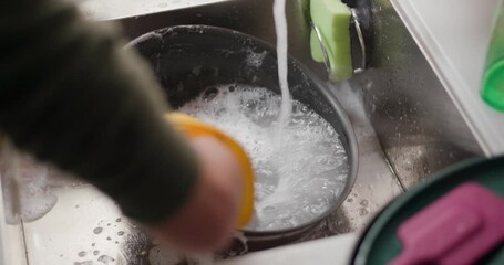 Housewife wash dishes at home