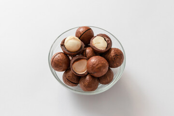 Macadamia nut shells macadamia in a glass jar on a gray concrete background