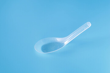 plastic spoon on wood background.