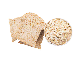 Top view of rolled oat flakes whole grain in bowl and whole wheat bread