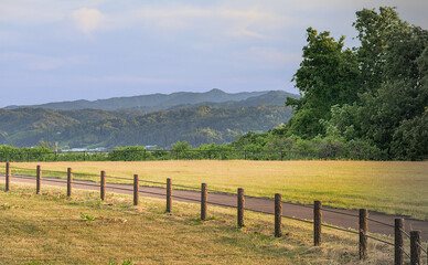 view of mountains with fence in foreground