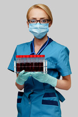 medical doctor nurse woman wearing protective mask and gloves - holding rack with virus blood tests