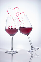 red wine glasses simulating love couple