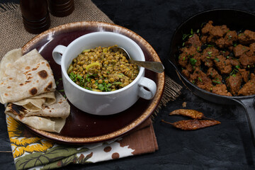 vegan lentil and celery stew served with flat breads and roasted seitan