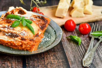   Delicious Home made Lasagna  with minced meat,tomato sauce and spinach  on a wooden rustic  background.Home made italian meal