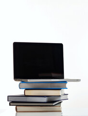 Elearning, books stack and a laptop isolated on white background