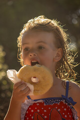 little girl  eating a donut