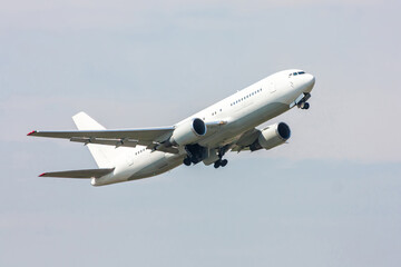Fototapeta na wymiar Take-off of a white passenger wide-body aircraft