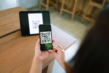 Qr code payment. Woman scanning QR code online shopping cashless technology concept.
