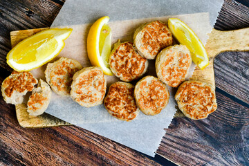 Home made italian  chicken  meatballs  with parmesan cheese, chily peppers and fresh  lemon on  rustic background. Diet food.
