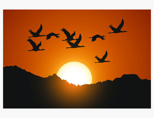 silhouette of birds flying over sunset