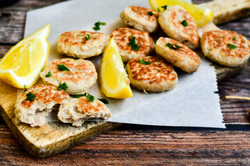 Home made italian  chicken  meatballs  with parmesan cheese, chily peppers and fresh  lemon on  rustic background. Diet food.