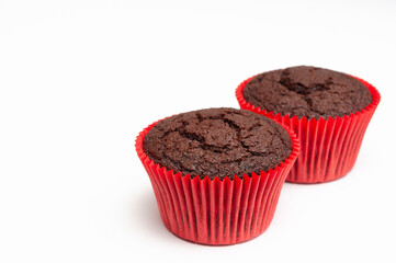 chocolate muffin in red tartlet. two. isolated on white background. place for inscription.