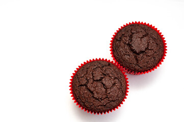 chocolate muffin in red tartlet. two. view from above. isolated on white background. place for inscription.