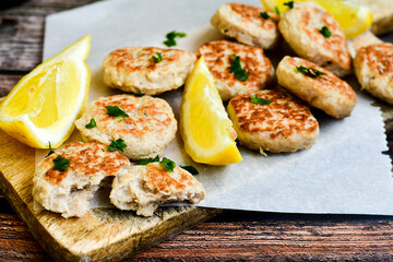 Home made italian  chicken  meatballs  with parmesan cheese, chily peppers and fresh  lemon on  rustic background. Diet food.
