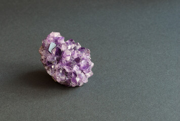 druse - amethyst crystals. on gray background. place for inscription.