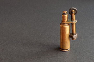 old petrol lighter from the second world war. isolated on black background. place for inscription.