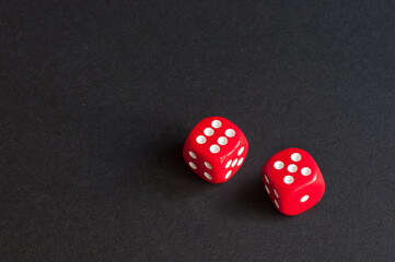 red dice on black background. concept: luck. place for inscription.