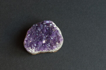 druse - amethyst crystals. on black background. place for inscription.