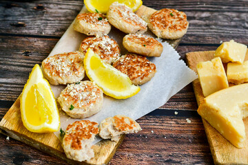 Home made italian  chicken  meatballs  with parmesan cheese, chily peppers and fresh  lemon on  rustic background. Diet food.