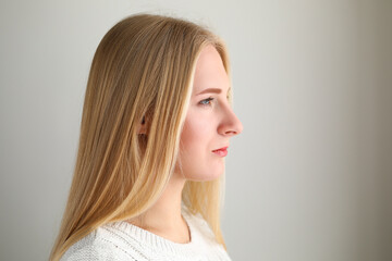 Attractive female wearing white sweater