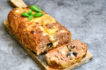 Home made baked  delicious  italian  traditional meatloaf filled  with cheese and mushrooms 