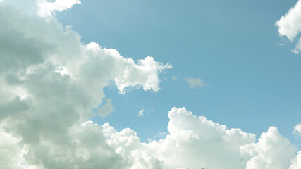 Naklejka na ściany i meble Fluffy white cloud with soft blue sky background texture