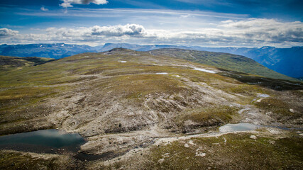 The road to the top of the mountains. Empty road of Norway. Bird's-eye view. Photos from the drone