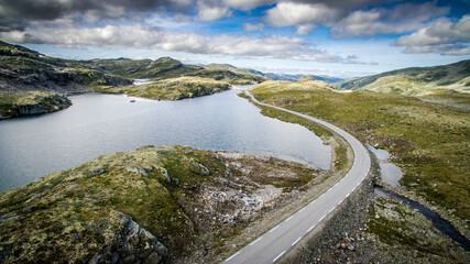The road to the top of the mountains. Empty road of Norway. Bird's-eye view. Photos from the drone