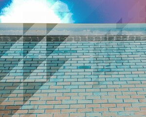 Abstract image of a brick wall and sky, with turquoise blue and shaded triangle effects