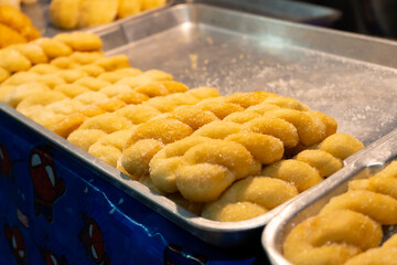 A showcase with pastries, rolls with colored fillers.