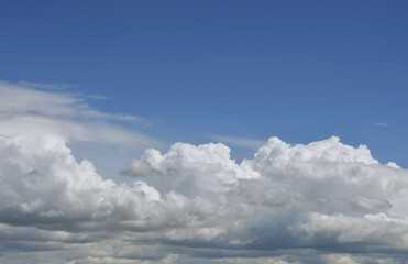 Fototapeta na wymiar Aerial view on moody thunder clouds flying on horizon under blue sky